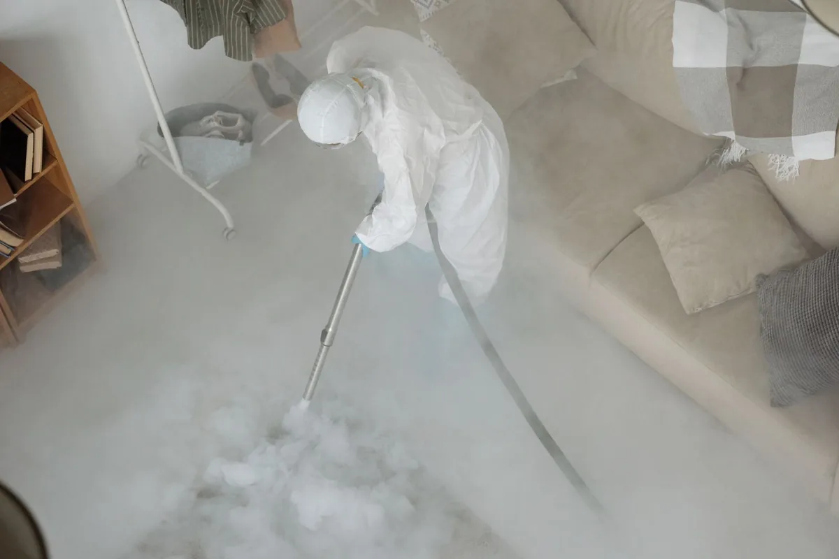 Biohazard cleanup technician in protective equipment, St. John, Austin, TX